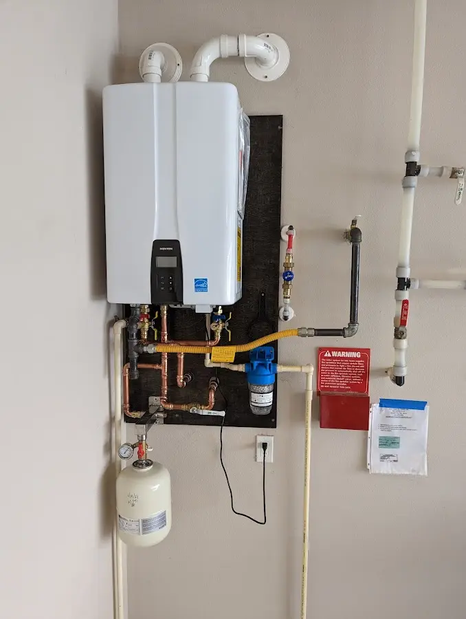 Professional plumber installing copper piping in a Birmingham home